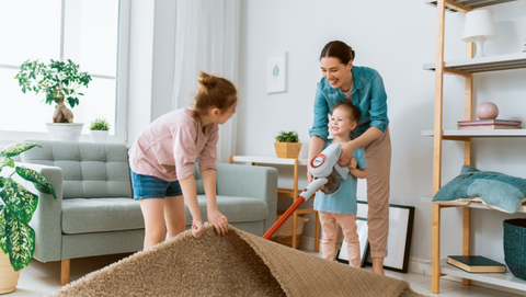 Mother Vacuuming with Two Kids
