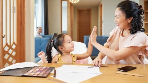 Mom giving daughter high five