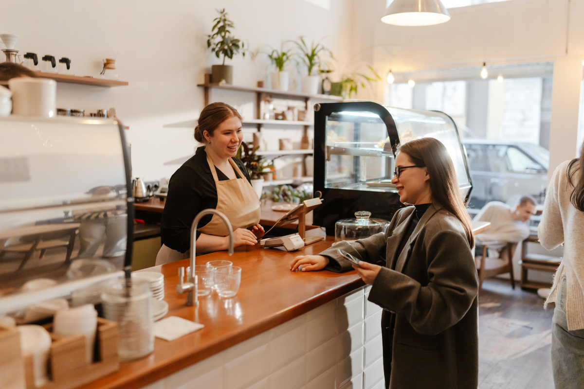 two ladies standing in a coffee shop
