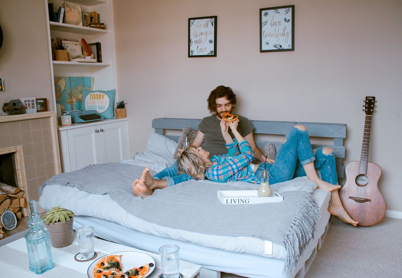couple laughing in a bed