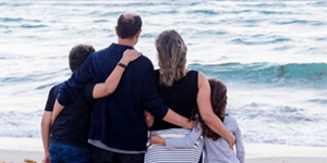 Family looking at Beach, Holding each other