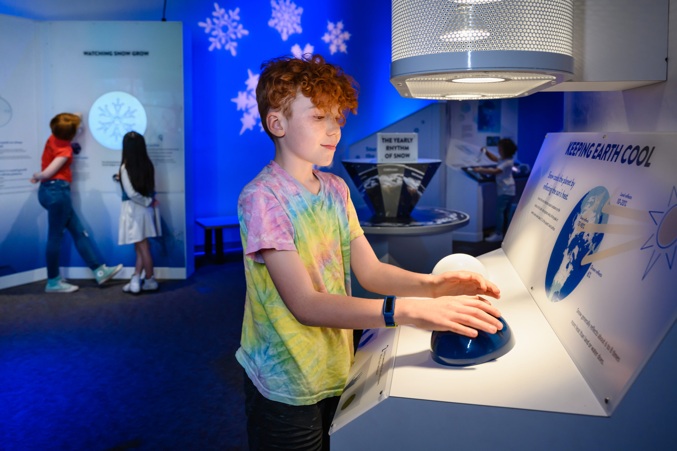 kid interacting with snow exhibit
