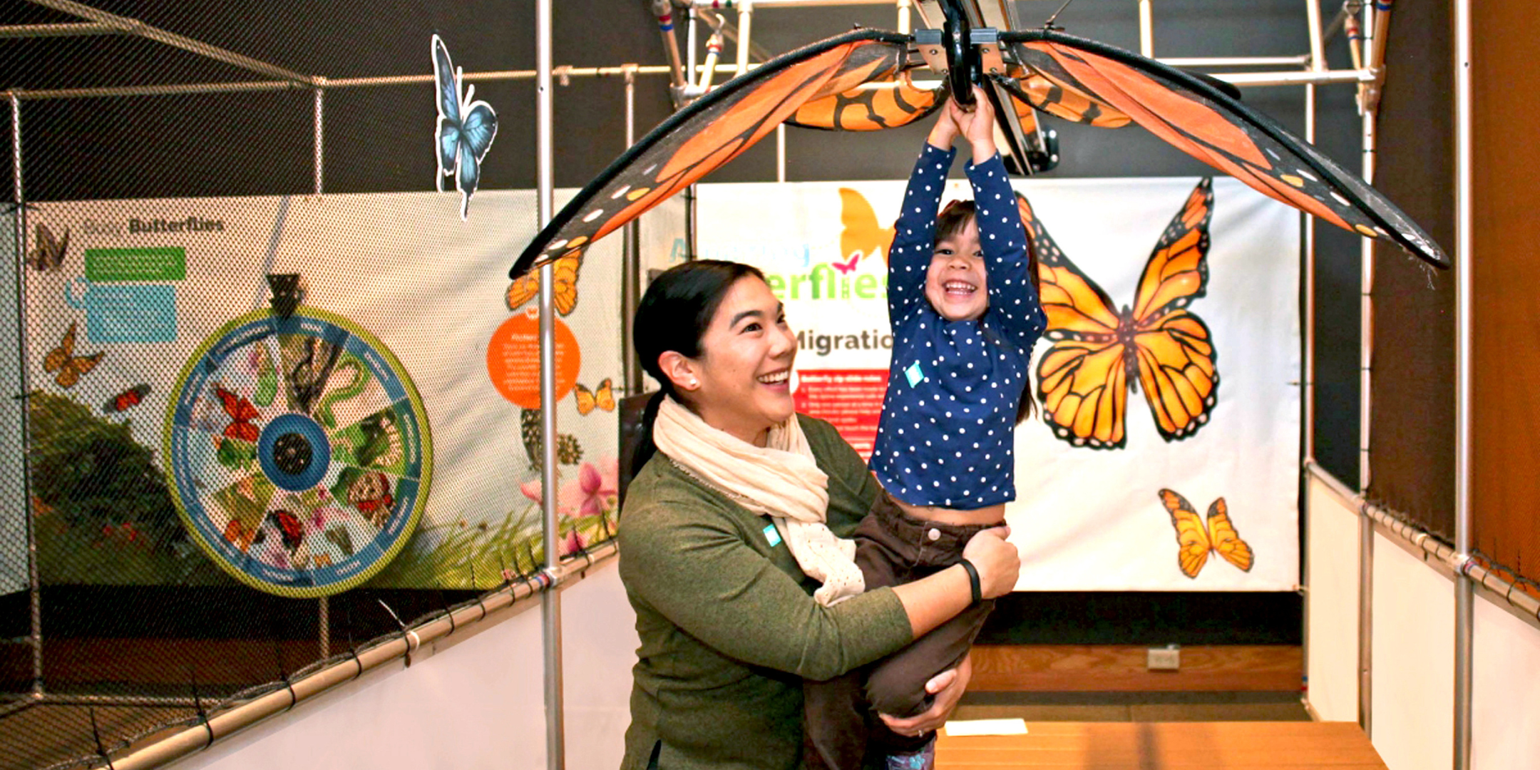 woman helping child slide down monorail