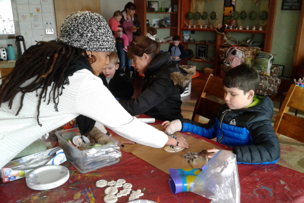 Volunteer helping child with craft
