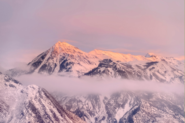 Snowy Wasatch mountains with clouds and pink sky