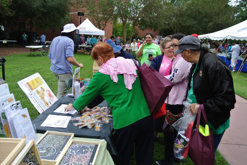 Women gathered around a booth display.