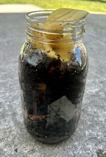 A jar filled with compost.