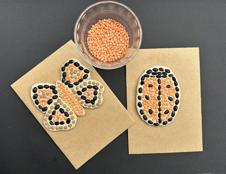 2 seed mosaics, one shaped like a butterfly and the other like a lady bug