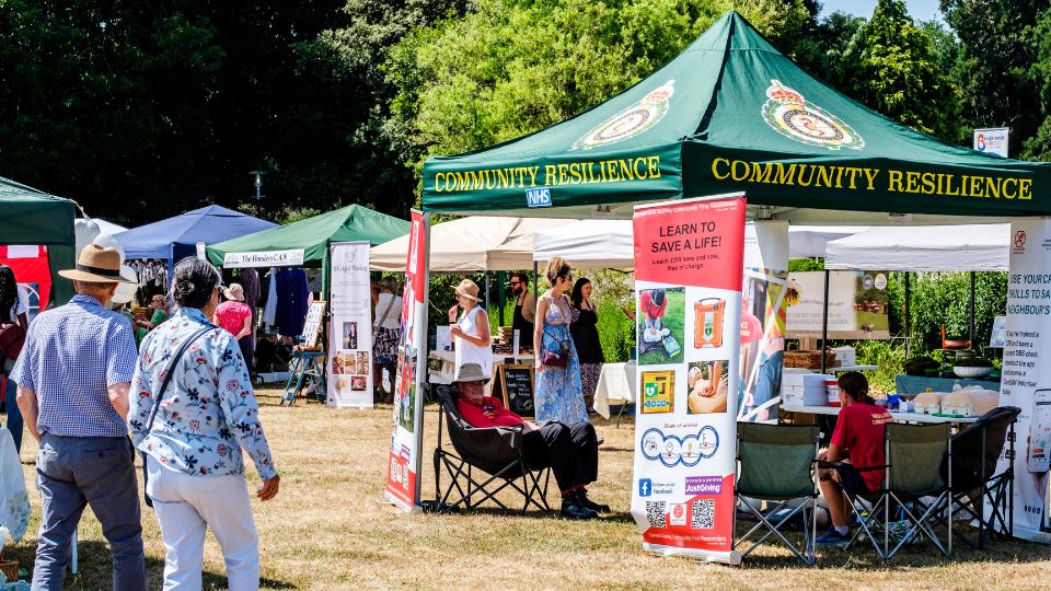 A green tent saying "Community Resilience" at an event.