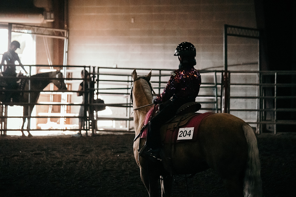 Youth participant on horse at a horse show 