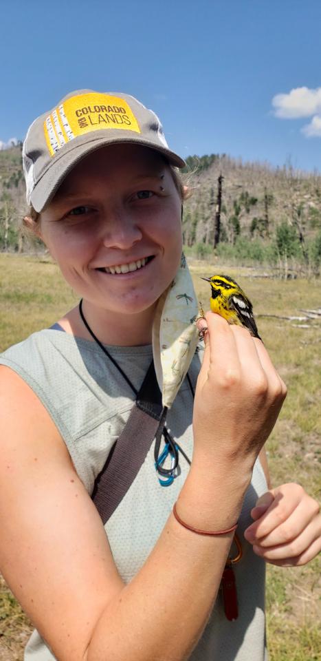 Zoe Moffett holding a yellow and black bird