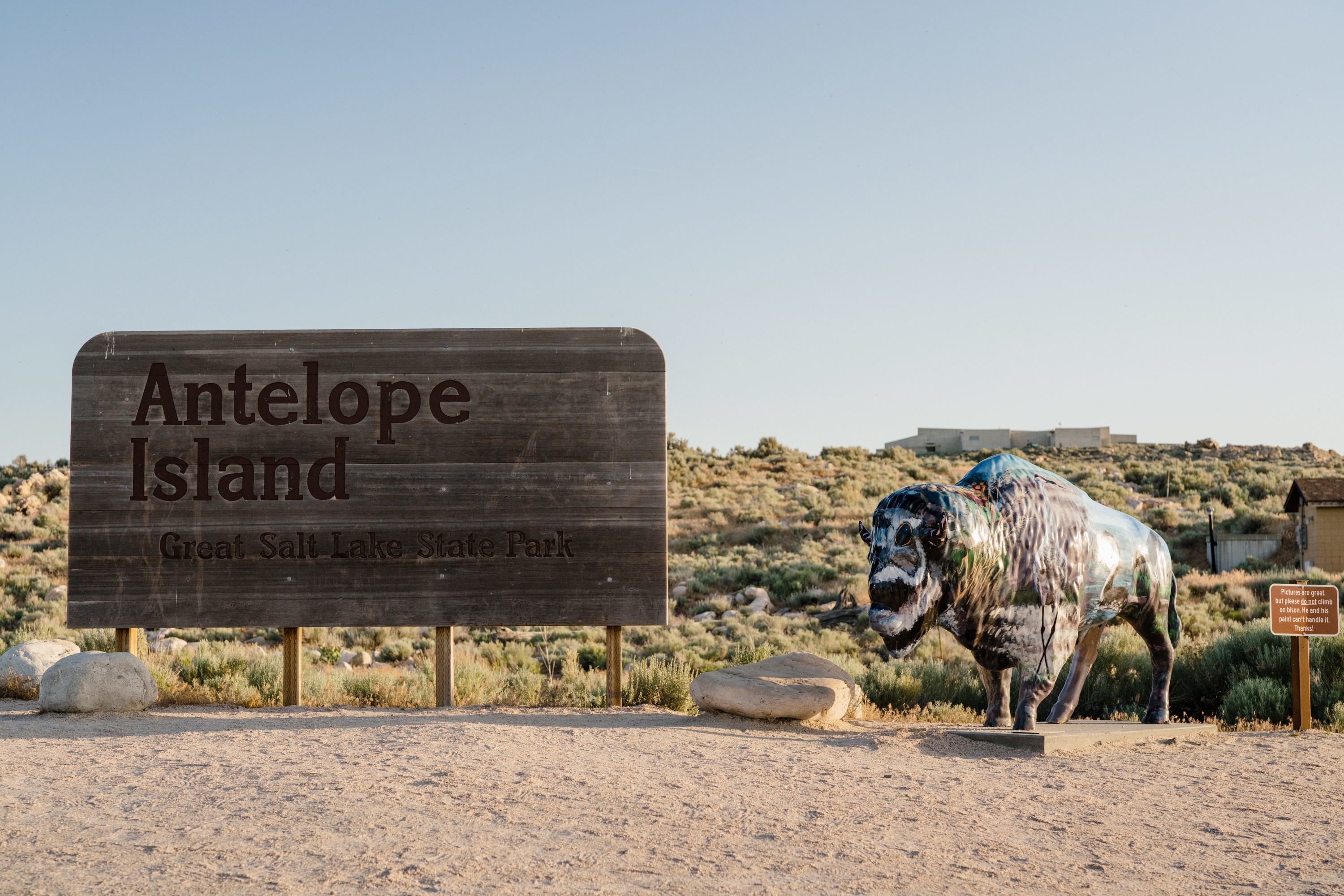 Antelope Island State Park sign with painted bison beside it